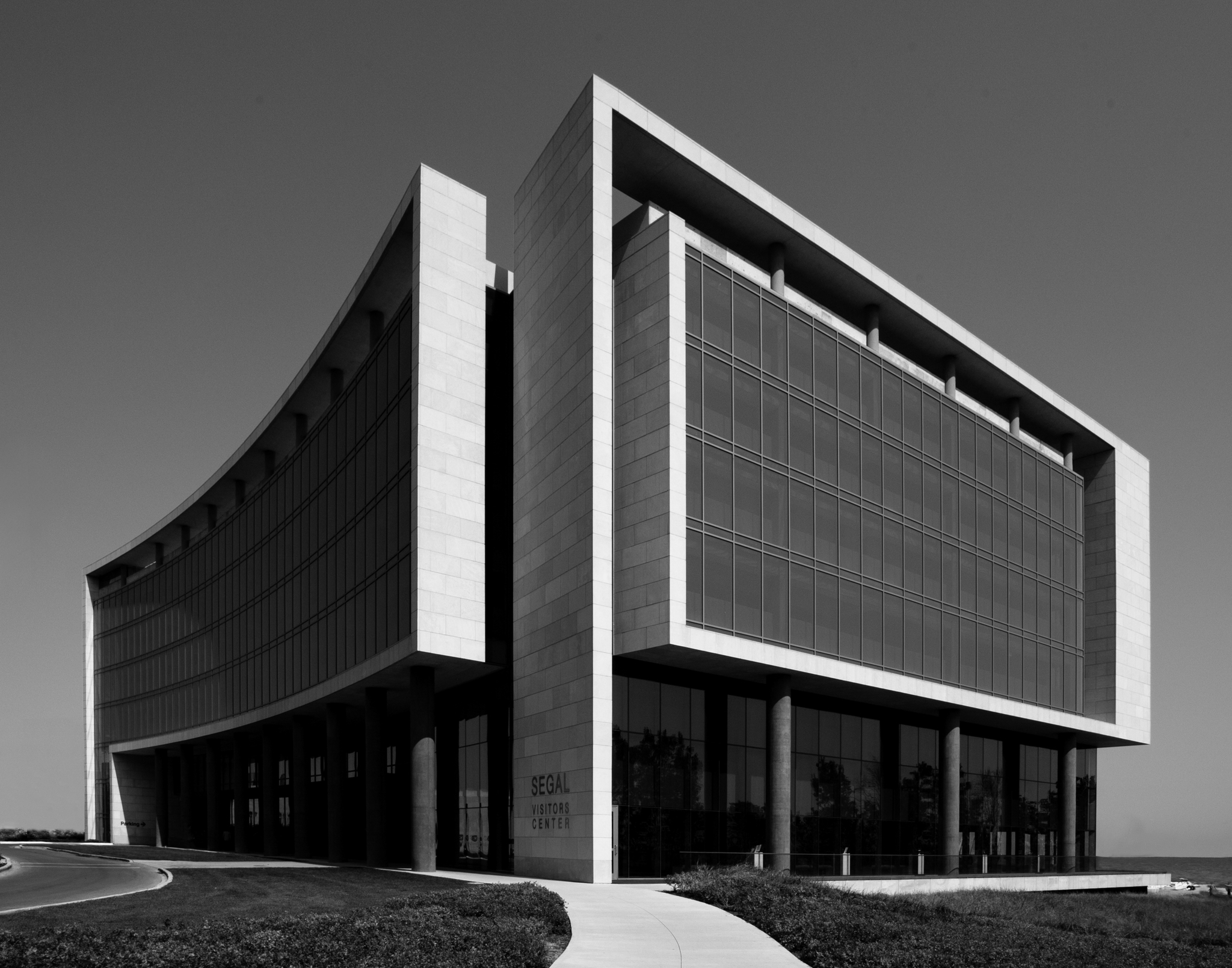 The curving lakefront façade of the Segal Visitors Center, framed by limestone and glass