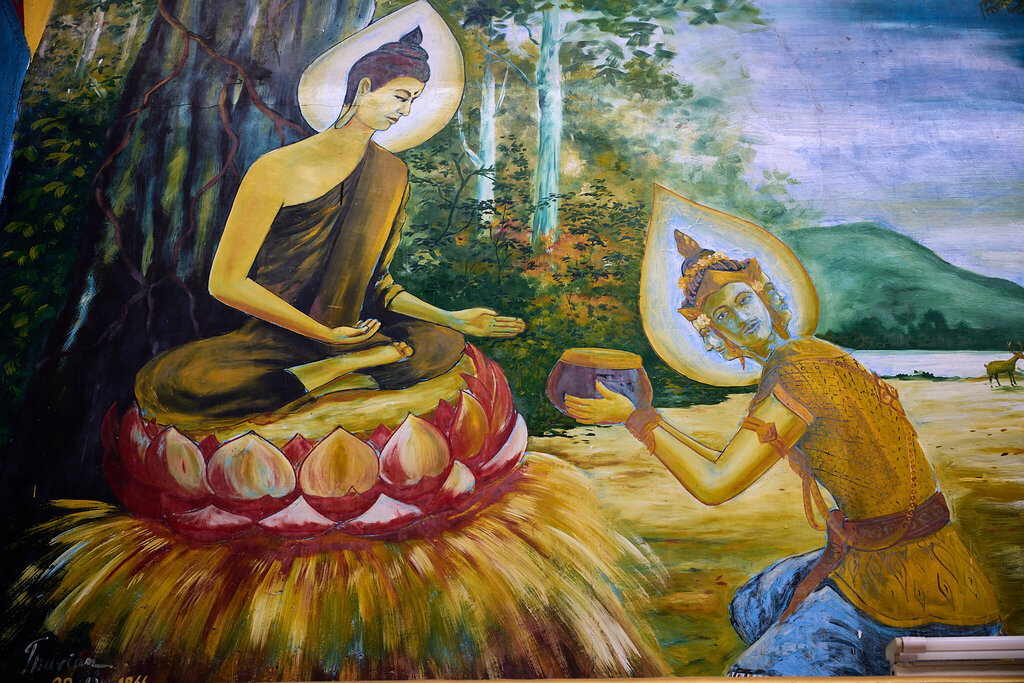A mural showing Sujata kneeling to offer milk-rice to Siddhartha